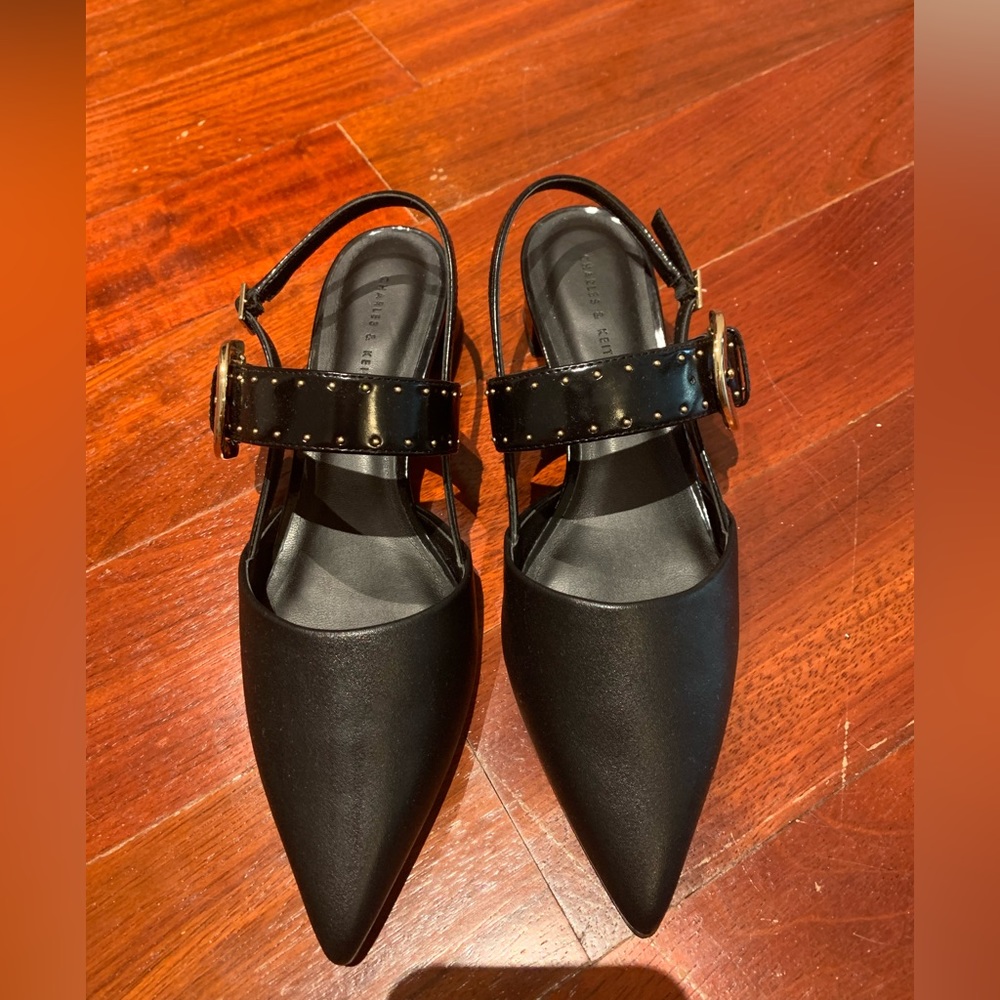 Brand new never worn Charles & Keith black Sepphe grommet slingback heels pumps